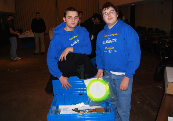 Members of the Comsewogue robotics team are pictured displaying the contents of the kit of parts.