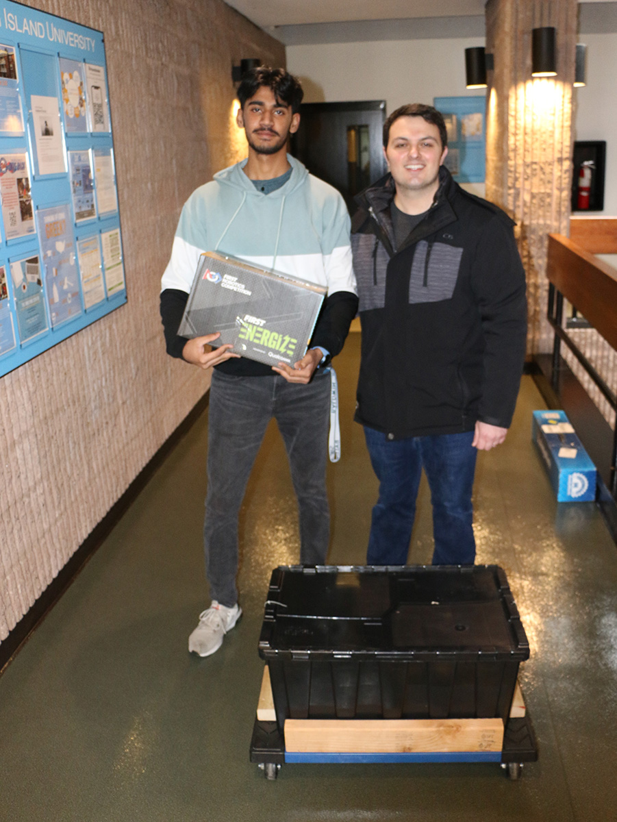 Members of the Syosset High School robotics team are pictured displaying the contents of the kit of parts. This is their first year competing in the FRC Long Island Regional.