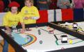 Two members of the Girl Scouts of Nassau County in Hicksville – Team 2052 "LEGO Chicks" guide their robot on the course at the January 11 Long Island LEGO League Tournament.